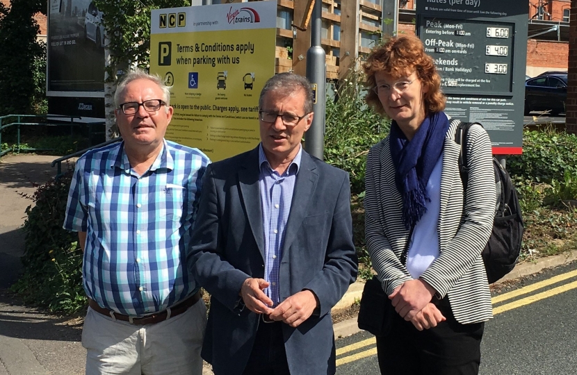 Rugby MP Mark Pawsey (centre) alongside the Chair of Rugby Rail Users Group, Stephanie Clifford (right) and RRUG member Tim Hosker (left) at Rugby Station car park following the announcement that prices are to rise in September