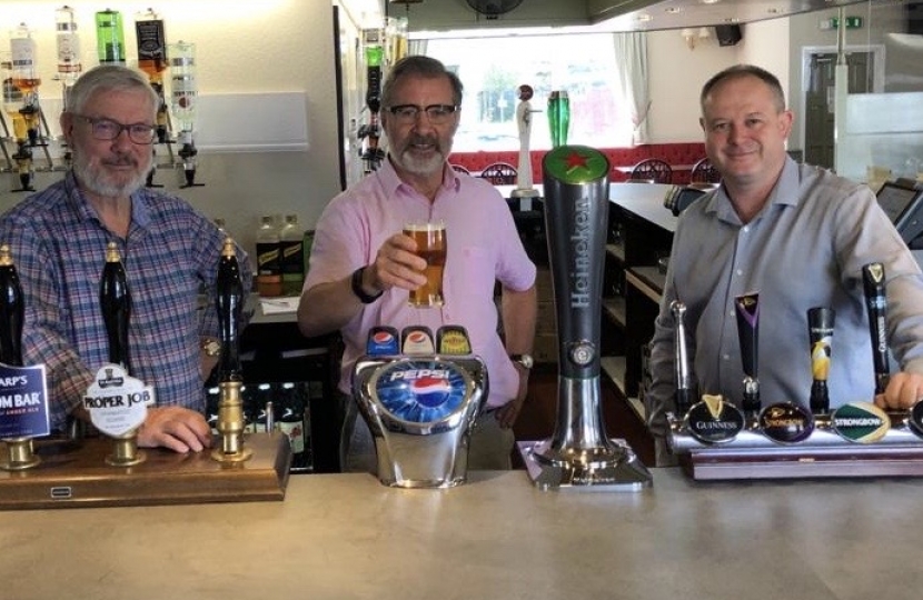 Rugby MP Mark Pawsey (centre) pulls a pint with David Hine, Fighting Cocks publican (left) and Julian Searle, , Regional Manager for the EI Group (right)