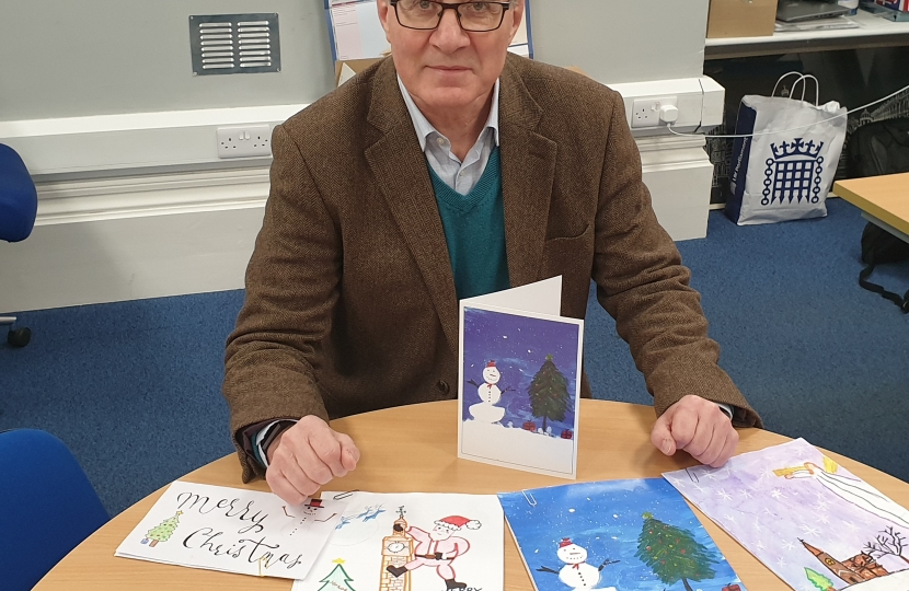 ugby MP Mark Pawsey with the winning design, the runners up and his Christmas card. (entries L-R: Lena Winiarczyk from St Andrew’s Benn CofE Primary School; Georgina Mair from Cawston Grange Primary School; Hannah Valayil, from English Martyrs Catholic Primary School; Paulina Gugala from St Marie’s Catholic Primary School