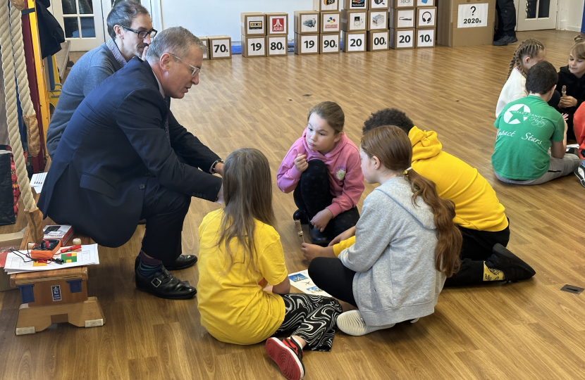 Rugby MP Mark Pawsey and Cllr Yousef Dahmash talk with pupils about their work on renewable energy