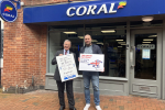 Rugby MP Mark Pawsey placing a bet on the Grand National at Coral in Rugby in support of the OurJay Foundation