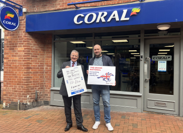 Rugby MP Mark Pawsey placing a bet on the Grand National at Coral in Rugby in support of the OurJay Foundation